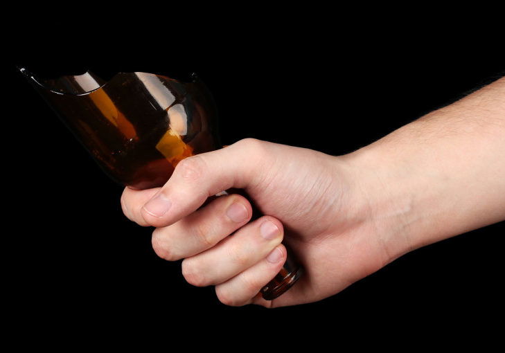 Male hand with broken glass bottle