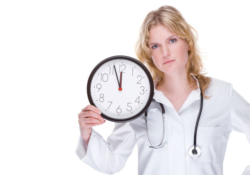 Full isolated portrait of a beautiful caucasian doctor with a clock