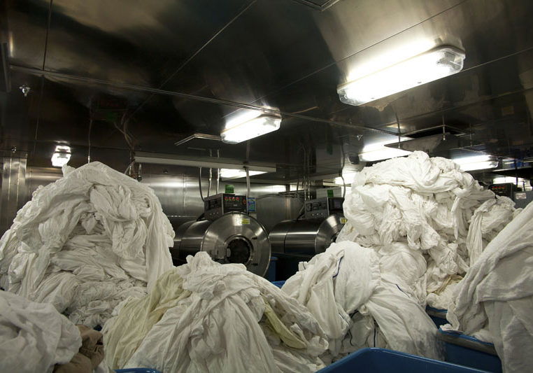 Laundry facility full of dirty sheets in the bowls of a cruise ship